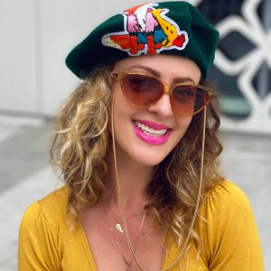 Zielony beret z rysunkową aplikacją na przedzie.